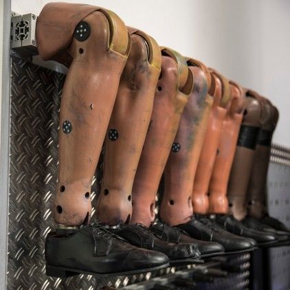 Row of crash test dummies with black shoes
