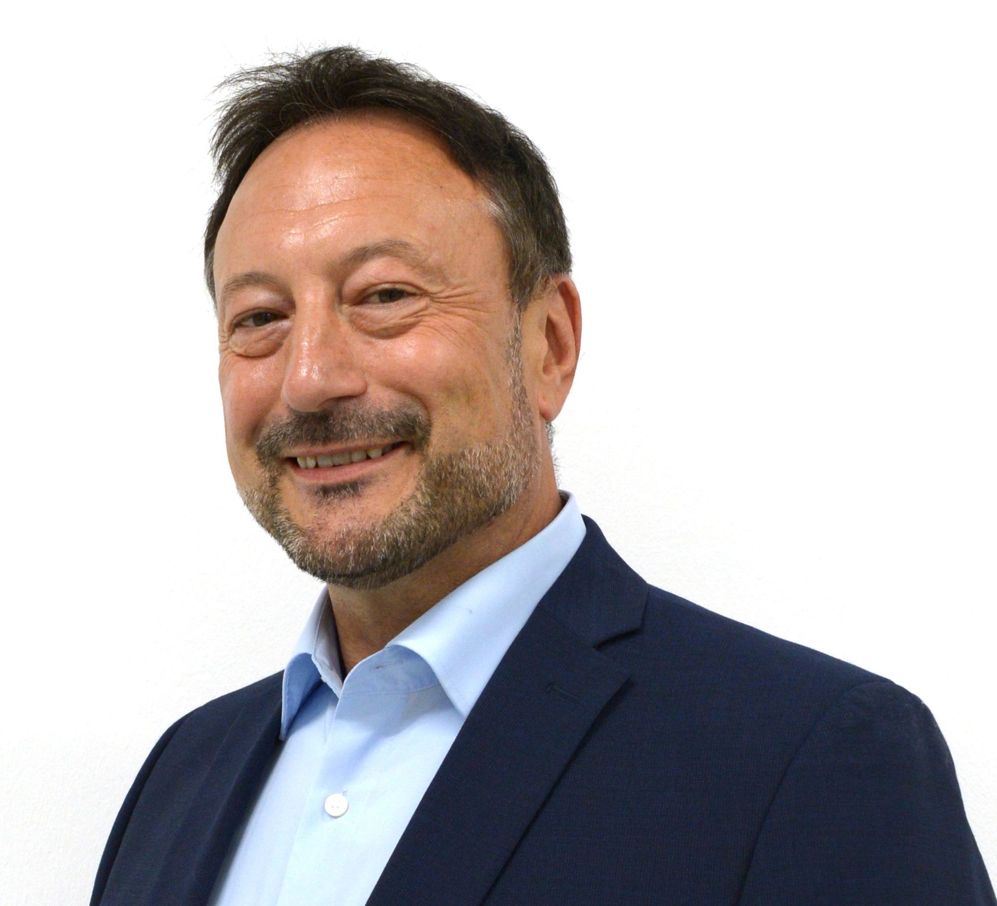 Man smiling, wearing suit and blue shirt