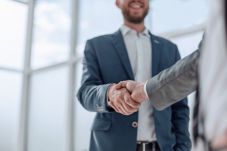 Businessmen shaking hands in an office setting
