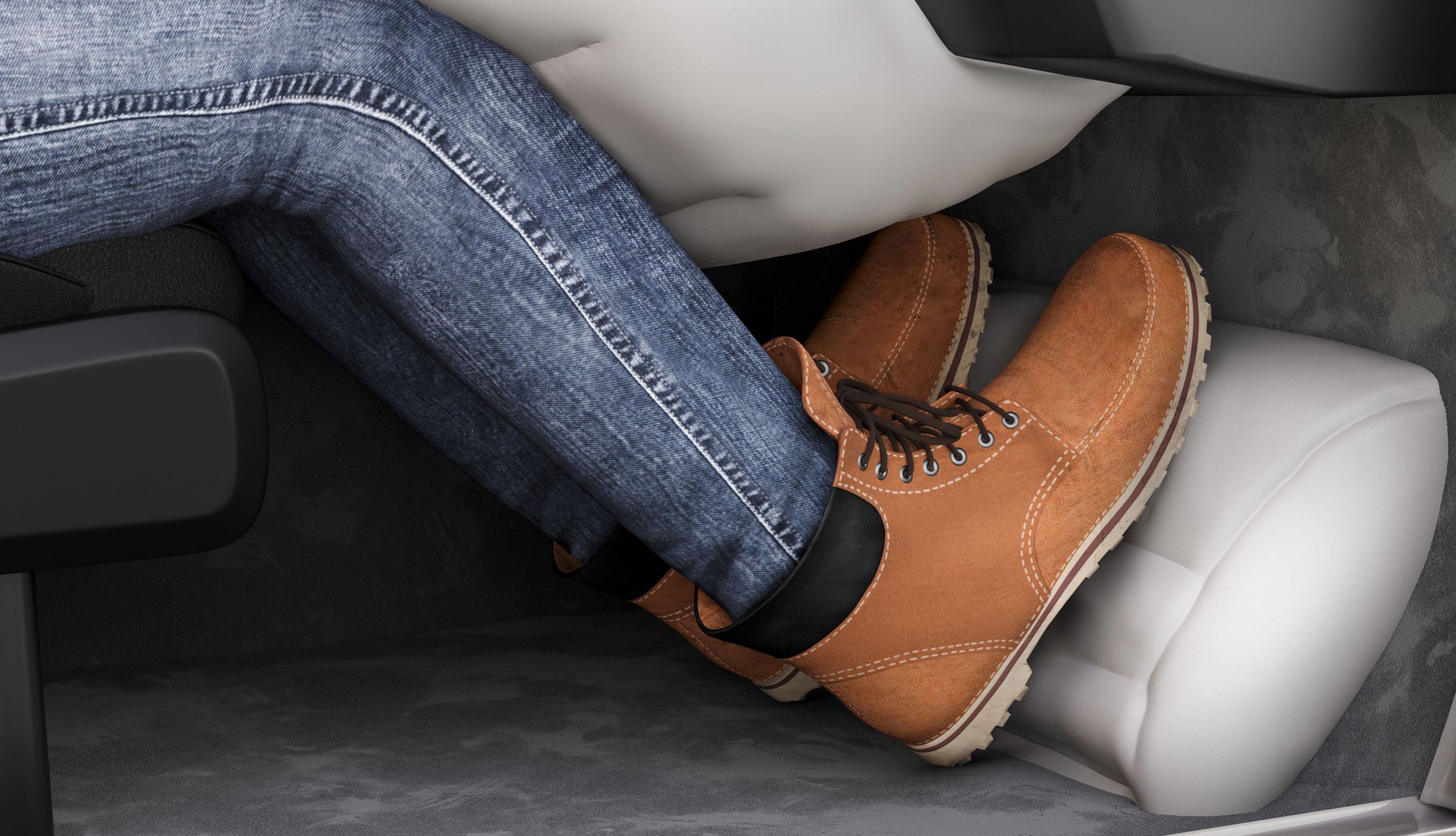 Person's legs in jeans and boots resting on car dashboard