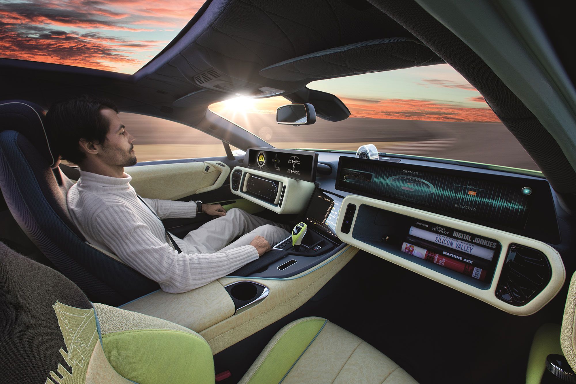 Man driving modern car with digital dashboard and sunset view
