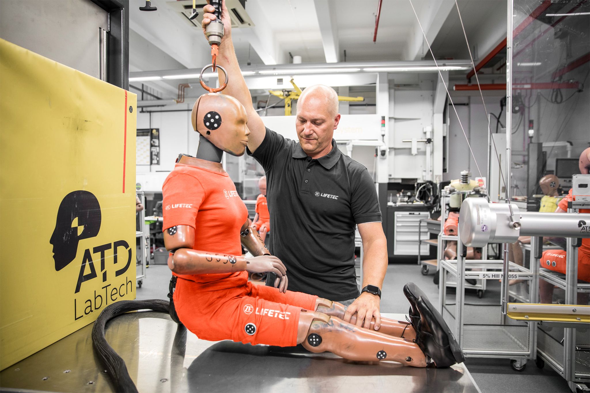 Engineer adjusting crash test dummy at ZF Lifetec facility