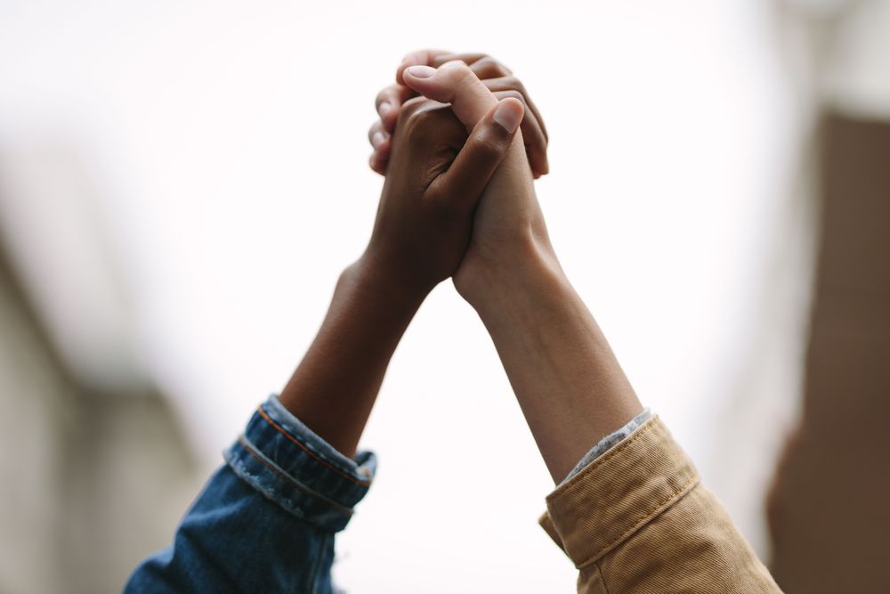 Two people holding hands