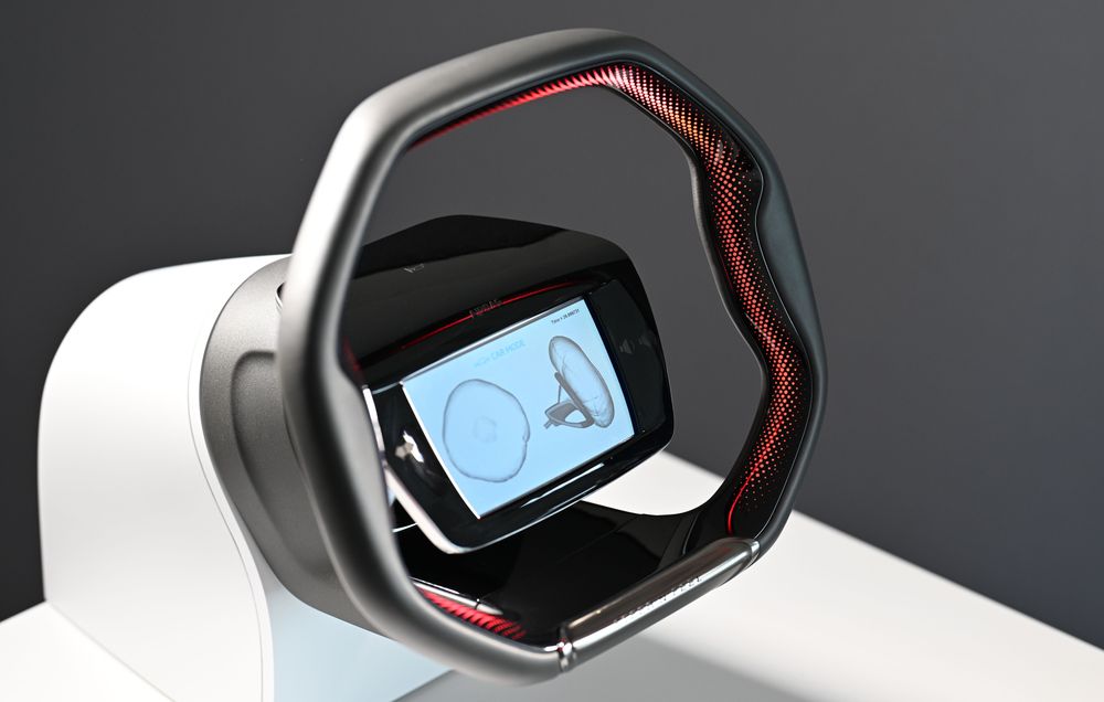 Car steering wheel with integrated display showing airbag and seatbelt icons