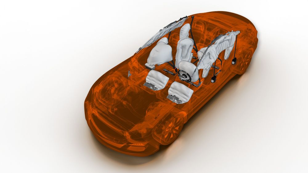 Car interior with deployed airbags and seat belts