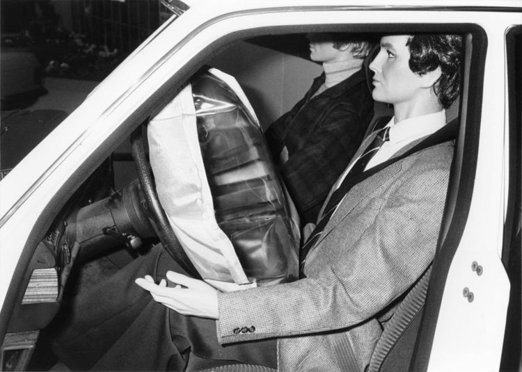 Man demonstrating airbag deployment in car