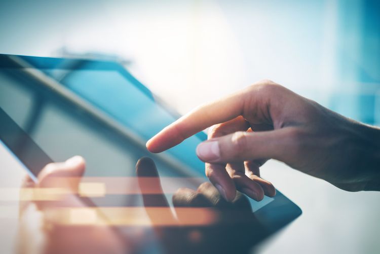 Hands using tablet with digital interface