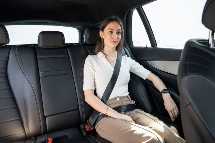 Woman wearing seatbelt in car