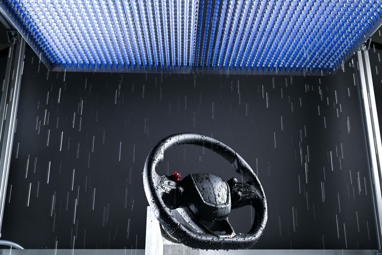 Car steering wheel with airbag in rain simulation chamber