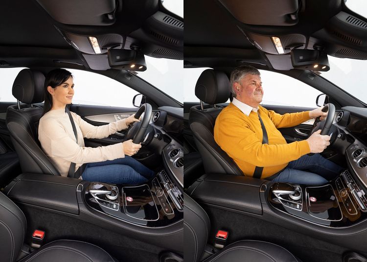 Man and woman using car safety belts and airbag systems