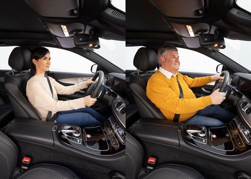 Man and woman using car safety belts and airbag systems