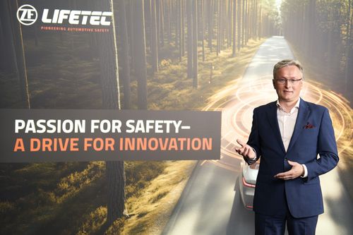 Man in suit next to car on forest road, LIFETEC logo and text 'Passion for Safety – A Drive for Innovation'